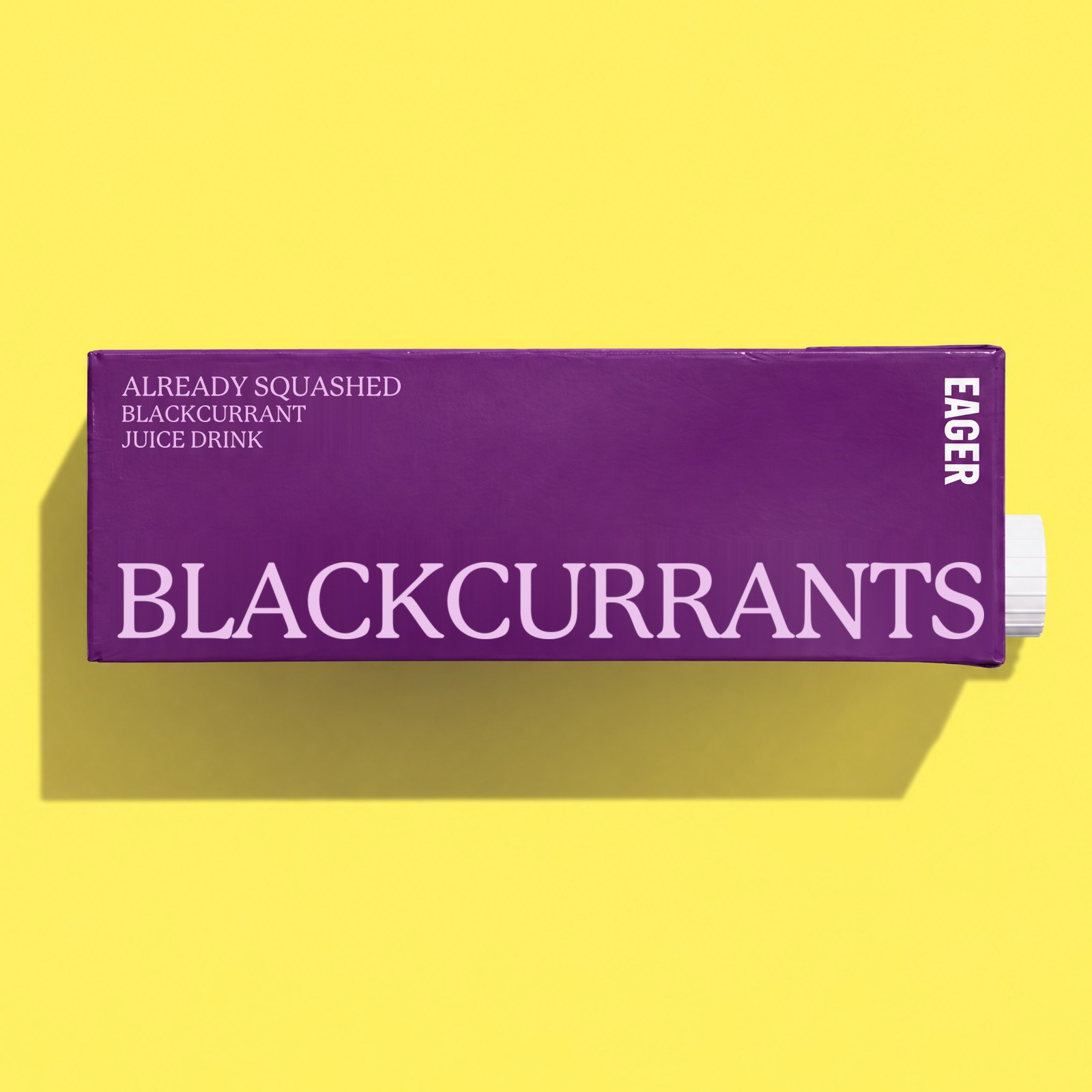 A deep purple Eager carton lying on a yellow background, with BLACKCURRANTS in large lilac serif capitals and the line Already squashed blackcurrant juice drink.
